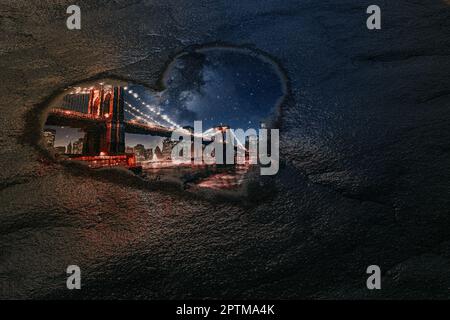 Love New York Concept. Reflection of Big Bridge Through Puddle in Shape of Heart extreme closeup. 3d Rendering Stock Photo