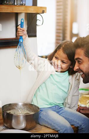 Hows this, Dad. a father and daughter making pancakes together Stock Photo