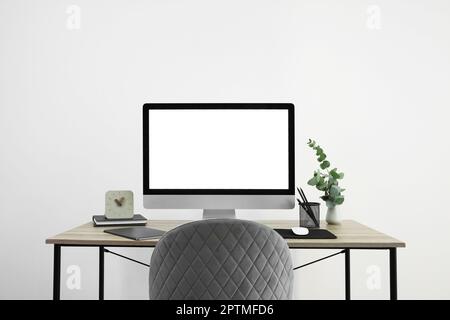 Modern computer with blank screen on desk, space for design. Comfortable workplace Stock Photo