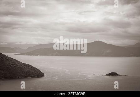 Old black and white picture of Panorama view from Abraaozinho on big tropical island Ilha Grande with drone from above to Portogalo Maciéis Angra dos Stock Photo