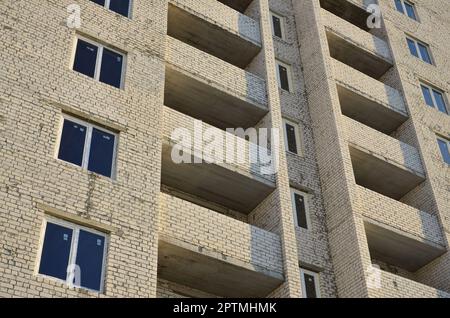 Photo of a newly built multi-storey building. Detailed photo of brick buildings with modern plastic windows Stock Photo