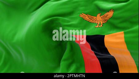 Close-up view of the Zambia national flag waving in the wind. The Republic of Zambia of Central and Southern Africa. Fabric textured background. Selec Stock Photo