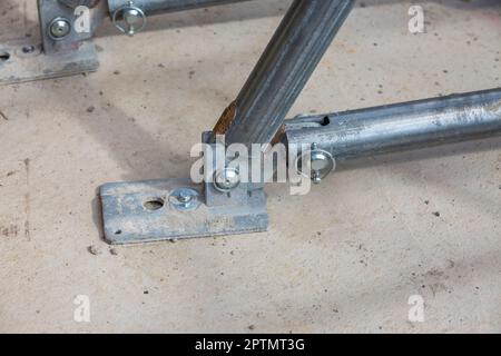 Scaffolding pipe clamp and parts, an important part of building strength to scaffold clamps in used close up on construction site,platforms for stage Stock Photo