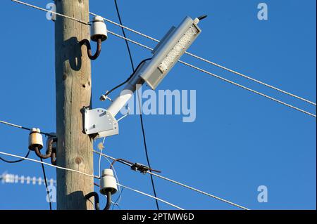 The LED street light is attached to a wooden pole. High quality photo Stock Photo