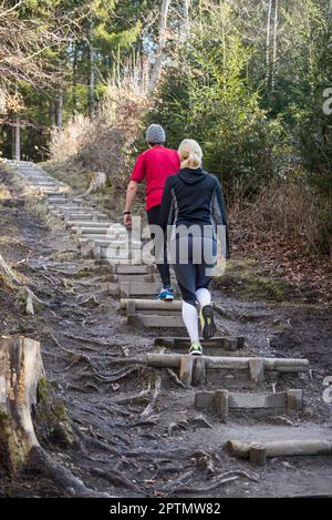 Couple doing training on stairs in nature Stock Photo