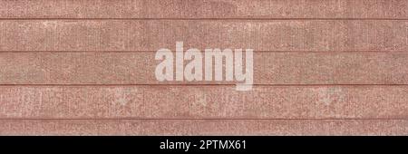 Red concrete wall with several horizontal grooves Stock Photo