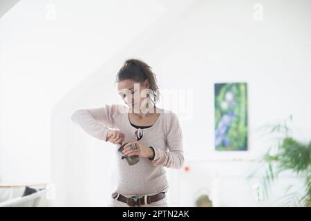 Female healer preparing medicine using mortar and pestle, Freiburg im Breisgau, Baden-Württemberg, Germany Stock Photo