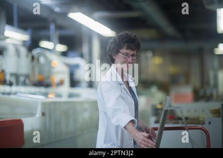 Female engineer working in industry, Hanover, Lower Saxony, Germany Stock Photo