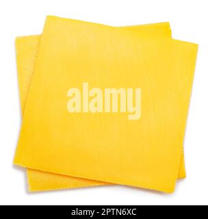 Square slices of meltable cheese, popular cheeseburger ingredient on white background. Stock Photo