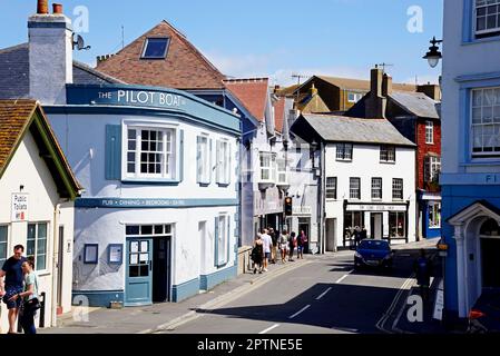 View of the Pilot Boat Pub and shops along Bridge Street in the old town, Lyme Regis, Dorset, UK, Europe. Stock Photo