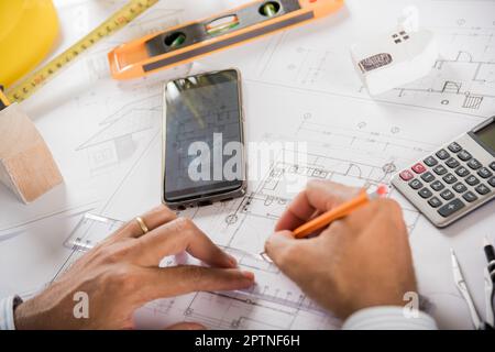 Architect workplace. Architectural building design and construction plans with blueprints paper project plans, designing man edit building or architec Stock Photo
