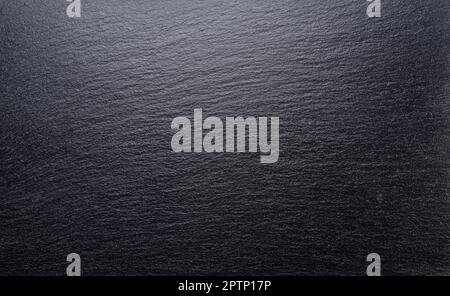 Natural stone black slate serving plate background. Stock Photo