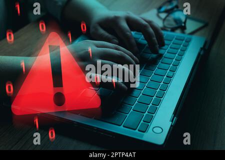 Woman solving cyber attacks on laptop. Compromised information concept. Malicious software, virus, cybercrime attacks. Warning alert about hacker. Stock Photo
