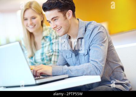Study buddies. Two smiling students helping each other with their homework. Stock Photo