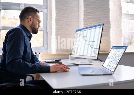 Employee Working On Calendar Schedule And Staff Time Sheet Stock Photo
