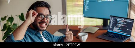 Male freelancer making new project as web designer or programmer on his computer at home office Stock Photo