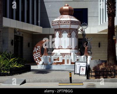 Cairo, Egypt, April 24 2023: festive decorations of Islamic Ramadan fasting month in Egyptian streets at daylight of stars, crescent moon, mosque mina Stock Photo