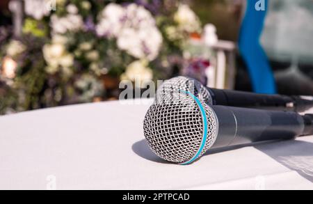 Two microphones lying on a table. Public speaking, performing Stock Photo