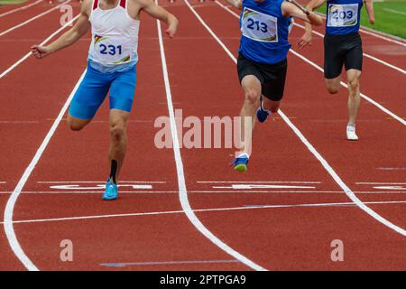 group runner para-athlete on limb deficiency running finish line track stadium, summer para athletics championships Stock Photo