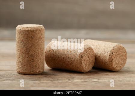 Corks of wine bottles on wooden table, closeup Stock Photo