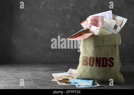 Eurobonds concept. Sack full of money on grey table, space for text Stock Photo