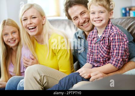 Relaxing together at home. Portrait of a happy family spending time together at home. Stock Photo