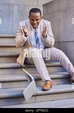 Businessman, laptop and mistake with damage, drop and fail while typing or reading email outdoor in the city. Black man, pc or technology with disaste Stock Photo