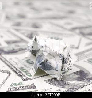 Crumpled dollar bill of the United States lies on the set of smooth money bills. Concept of unreasonable waste of money Stock Photo