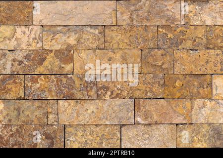 Rust-colored sandstone wall. Natural, rustic style construction. Stock Photo