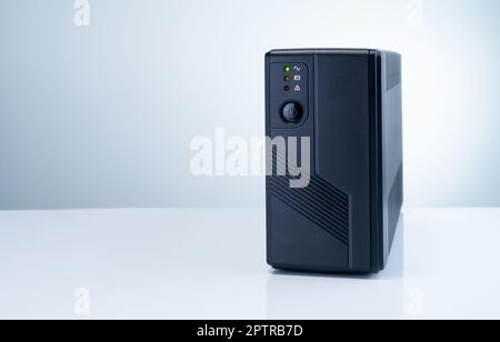 Uninterruptible power supply on white background. Backup Power UPS with battery. UPS with stabilizer for home PC. UPS inverter. Equipment for computer Stock Photo