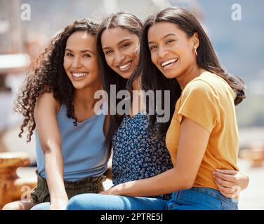 Unexpected friendships are the best ones. Portrait of a group of young women hanging out together outdoors Stock Photo
