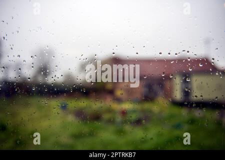 Raindrops on a window on a wet day in East Yorkshire Stock Photo