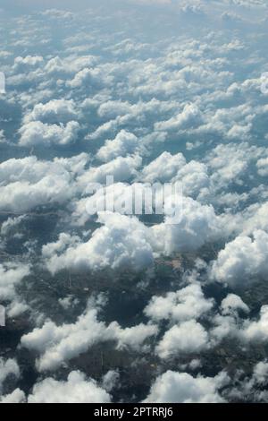 Cumulus clouds seen from above. Cloudscape at high altitude. Heaven, flying, freedom concept. Stock Photo