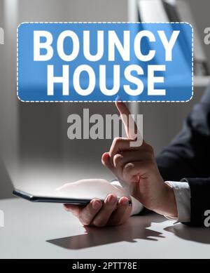 Sign displaying Bouncy House, Word for Automated program that runs over the Internet Artificial intelligence Stock Photo