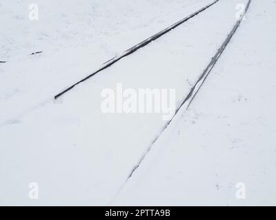 Railway in the snow. Rails covered by a snowstorm. Railway service, snow removal. Transport concept. Snowdrifts and drifts. Difficult weather conditio Stock Photo