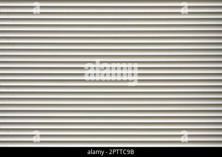 The texture of corrugated metal sheet, white or grey slide door. Old roller shutter texture for background Stock Photo