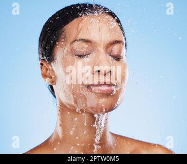 Beauty, skincare and shower with black woman and water splash for cleaning, hydration and natural cosmetics. Moisture, fresh and relax with face of gi Stock Photo