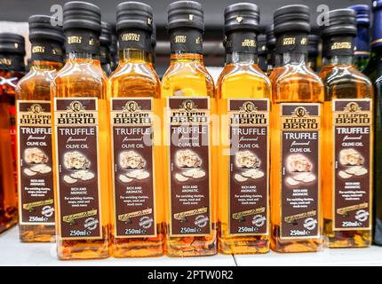 Samara, Russia - April 21, 2023: Filippo Berio truffle olive oil in bottles on the shelf in a superstore. Bottled olive oils. Selective focus Stock Photo