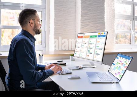 Digital Calendar Schedule Software In Office. Scrum Mobile Phone App Stock Photo