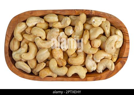 Cashews in a wooden bowl against white background Stock Photo