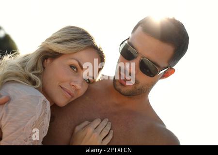 Theirs is a perfect love. Head and shoulders portrait of an attractive young woman embracing her husband on a sunny day Stock Photo