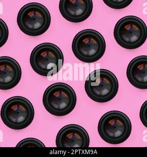 A few camera lenses with a closed aperture lie on texture background of fashion pastel pink color paper in minimal concept. Abstract trendy pattern. Stock Photo