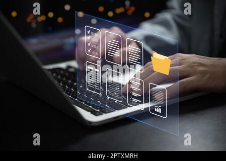 Businessman working online data and document system on laptop with virtual screen. Online database and document management system and keep in security Stock Photo