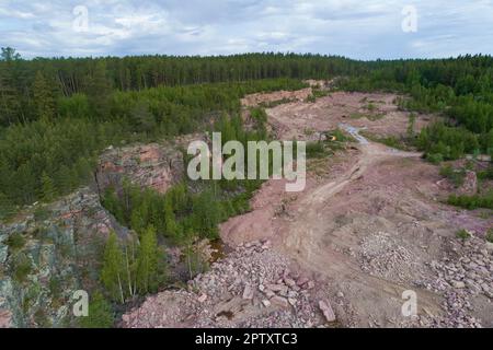 Top view of an old red quartzite quarry on a cloudy June day. Shoksha, Karelia. Russia Stock Photo
