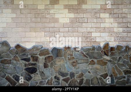 Rustic old beige white brick wall background and worn foundation with shabby brown stones Stock Photo