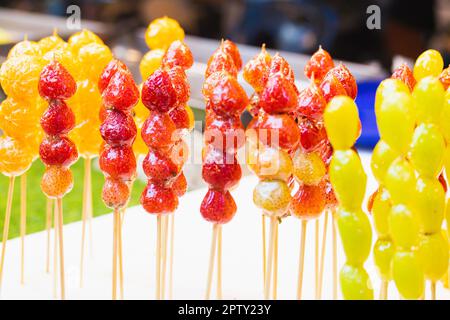 Skewers of sugar-coated fruit Stock Photo