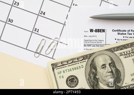 IRS Form W-8BEN Certificate of foreign status of beneficial owner for United States tax withholding and reporting for individuals blank lies with pen Stock Photo