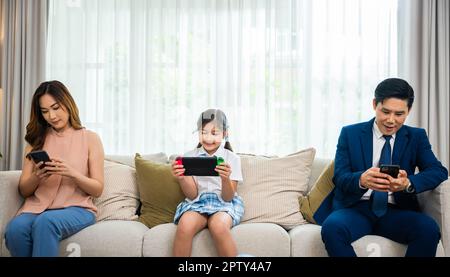 https://l450v.alamy.com/450v/2pty4a7/family-dont-care-about-each-other-asian-parents-ignore-their-child-and-looking-at-their-mobile-phone-at-home-gadgets-dependence-overuse-internet-so-2pty4a7.jpg