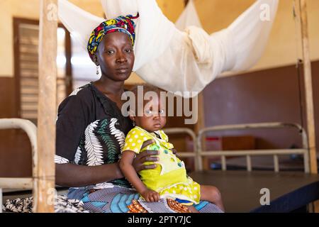 Mother and young child admitted to hospital for malnutrition and malaria in Segou Region, Mali, West Africa. 2022 Mali drought and hunger crisis. Stock Photo