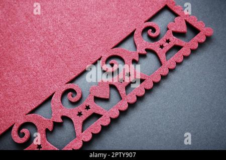 Background New Year's or for Valentine's Day. Kissing goats with stars and hearts are carved on red felt fabric. Merry Christmas and Happy New Year. P Stock Photo